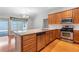 Well-lit kitchen featuring stainless steel appliances and wooden cabinets at 307 Jessica Way, Canton, GA 30114