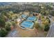 Aerial view of tennis courts amid lush trees and landscaping, offering a private, active space at 307 Jessica Way, Canton, GA 30114