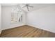 Bright bedroom with a ceiling fan, large window with white blinds, and wood-look floors at 3858 Vineyards Lake Nw Cir # U-19, Kennesaw, GA 30144