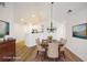 Staged dining room featuring wood floors, chandelier, and comfortable seating at 3858 Vineyards Lake Nw Cir # U-19, Kennesaw, GA 30144