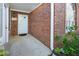 A brick front porch with a white door and trim, showing well-kept landscaping and a welcoming entrance at 3858 Vineyards Lake Nw Cir # U-19, Kennesaw, GA 30144