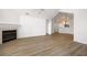 Spacious living area with wood flooring, a fireplace, and a view into the adjacent room and sunroom at 3858 Vineyards Lake Nw Cir # U-19, Kennesaw, GA 30144