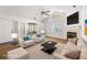 Staged living room features stylish furniture, neutral tones, fireplace, and abundant natural light at 3858 Vineyards Lake Nw Cir # U-19, Kennesaw, GA 30144