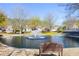 Community pond view with fountain, bench, and lovely landscaping offering a serene outdoor space at 3858 Vineyards Lake Nw Cir # U-19, Kennesaw, GA 30144