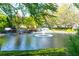 Scenic pond with fountains, walking bridge and colorful foliage enhancing the natural beauty at 3858 Vineyards Lake Nw Cir # U-19, Kennesaw, GA 30144