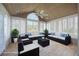 Staged sunroom featuring tile flooring, many windows, vaulted ceiling, and comfortable seating arrangement at 3858 Vineyards Lake Nw Cir # U-19, Kennesaw, GA 30144