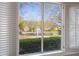 Charming view of a tranquil pond and fountain seen through white shutters at 3858 Vineyards Lake Nw Cir # U-19, Kennesaw, GA 30144