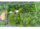 The property features a home, a detached garage, driveway, lawn, and wooded views at 505 Cedar Creek Nw Rd, Cartersville, GA 30121