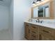 Bathroom vanity with granite countertop, wood cabinets, and a large mirror at 505 Cedar Creek Nw Rd, Cartersville, GA 30121