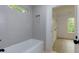 Bathroom features a white tub, white subway tiles, white grout, and a recessed shelf for bath products at 505 Cedar Creek Nw Rd, Cartersville, GA 30121