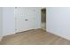 Bedroom featuring wood-look floors, white walls, double door closet and a bathroom walkthrough at 505 Cedar Creek Nw Rd, Cartersville, GA 30121