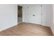 Bedroom featuring wood-look floors, white walls, double door closet and a bathroom walkthrough at 505 Cedar Creek Nw Rd, Cartersville, GA 30121