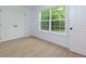 Bedroom features wood-look floors, white walls, natural light from window, and a double door closet at 505 Cedar Creek Nw Rd, Cartersville, GA 30121