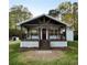 Charming cottage-style home with a covered porch, exposed beams, and manicured lawn at 505 Cedar Creek Nw Rd, Cartersville, GA 30121