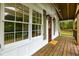 Inviting front porch featuring a wood deck and railing, enhanced by ample natural light at 505 Cedar Creek Nw Rd, Cartersville, GA 30121