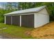 Exterior of the garage showcasing three wooden garage doors at 505 Cedar Creek Nw Rd, Cartersville, GA 30121
