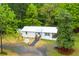 Charming home boasts a white exterior, a welcoming porch, and a well-manicured lawn at 505 Cedar Creek Nw Rd, Cartersville, GA 30121