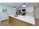 Stylish kitchen featuring a center island, white cabinets, stainless steel appliances, and a door to the outdoors at 505 Cedar Creek Nw Rd, Cartersville, GA 30121