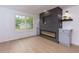 Bright living room featuring a modern fireplace, built-in cabinets, and large windows at 505 Cedar Creek Nw Rd, Cartersville, GA 30121