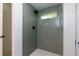 Modern bathroom featuring a shower with green tiling, white grout, and a frameless glass enclosure at 505 Cedar Creek Nw Rd, Cartersville, GA 30121