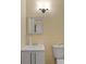 Small bathroom featuring toilet, mirror, vanity and natural colored walls at 6860 Robinson St, Lithonia, GA 30058