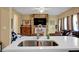 Bright kitchen opens to living room featuring quartz counters and stainless steel appliances at 6860 Robinson St, Lithonia, GA 30058