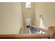 Bright staircase with a modern chandelier, and wood railing at 6860 Robinson St, Lithonia, GA 30058