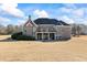 This home includes a covered patio, balcony, large backyard and a built in stone fire pit, great for entertaining at 135 Antoinette Ave, Mcdonough, GA 30252