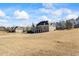 The property features a large, open yard with the home featuring a walkout patio and a second-story balcony at 135 Antoinette Ave, Mcdonough, GA 30252