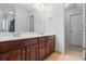 Bathroom boasts dark wood cabinets, double sinks and a large mirror, providing functionality at 135 Antoinette Ave, Mcdonough, GA 30252