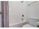 A clean, white bathroom features a shower-tub combination with a shower curtain and updated fixtures at 135 Antoinette Ave, Mcdonough, GA 30252