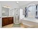 Bathroom featuring a soaking tub, walk-in shower, and and sinks at 135 Antoinette Ave, Mcdonough, GA 30252
