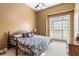 Cozy bedroom with a large window, neutral wall paint, and a ceiling fan at 135 Antoinette Ave, Mcdonough, GA 30252
