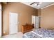 Bedroom featuring tan walls, a large window, and an ensuite bathroom at 135 Antoinette Ave, Mcdonough, GA 30252
