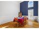 Elegant dining room with hardwood floors, ample natural light, and stylish blue accent wall at 135 Antoinette Ave, Mcdonough, GA 30252