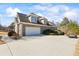 A side view showcases the house's brick exterior and attached garage, with ample driveway space at 135 Antoinette Ave, Mcdonough, GA 30252