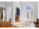 Bright foyer with elegant tile flooring, soaring ceilings, and an arched doorway leading to the dining room at 135 Antoinette Ave, Mcdonough, GA 30252