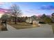 Stunning home with mature trees, manicured lawn, and beautiful landscaping create an inviting curb appeal at 135 Antoinette Ave, Mcdonough, GA 30252