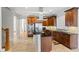 Modern kitchen featuring stone floors, wooden cabinetry, an island, and stainless steel appliances at 135 Antoinette Ave, Mcdonough, GA 30252