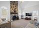 Bright living room with a stone fireplace, neutral walls, and light carpet at 135 Antoinette Ave, Mcdonough, GA 30252