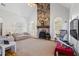 Spacious living room featuring a stone fireplace, high ceilings, and natural light at 135 Antoinette Ave, Mcdonough, GA 30252