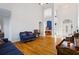 Bright, open-concept living space with hardwood floors, high ceilings, and decorative furnishings at 135 Antoinette Ave, Mcdonough, GA 30252