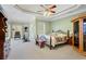 Spacious bedroom featuring lots of natural light, exercise equipment, ceiling fan, and an en suite bathroom at 135 Antoinette Ave, Mcdonough, GA 30252