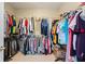 Walk in closet with racks of organized clothes at 135 Antoinette Ave, Mcdonough, GA 30252