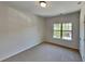 A bright room showcasing carpeted floors and a window with a view of the outdoors at 156 Crescent Wooode Dr, Dallas, GA 30157