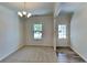 Bright dining space with carpet, chandelier, and easy access to the outside, ideal for entertaining at 156 Crescent Wooode Dr, Dallas, GA 30157