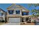 Charming two-story home with stone accents, a two-car garage, and a welcoming covered porch at 156 Crescent Wooode Dr, Dallas, GA 30157