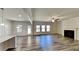 Open-concept living area with wood floors, fireplace, and a seamless flow to the kitchen at 156 Crescent Wooode Dr, Dallas, GA 30157