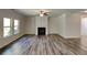 Spacious living room with wood floors, a cozy fireplace, and plenty of natural light at 156 Crescent Wooode Dr, Dallas, GA 30157