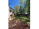 The backyard of the home with a balcony and wooden fencing on a bright, sunny day at 2245 Panstone Sw Dr, Marietta, GA 30060